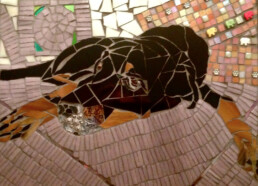 Mosaic of black dog named Vishnu