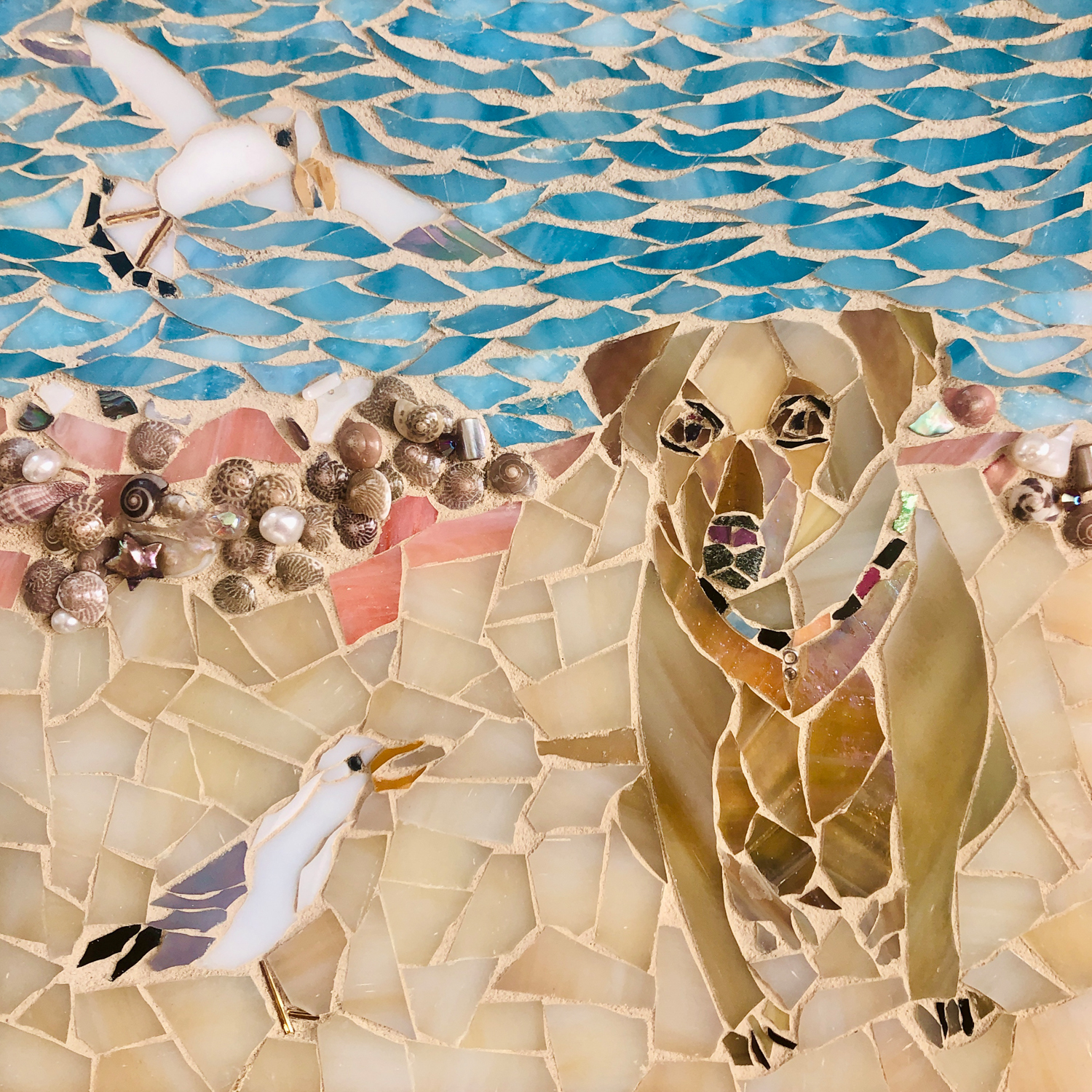 Mosaic of a dog named Riley with flying seagulls
